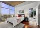 Bedroom showcasing a scenic city view through expansive windows and hardwood flooring at 1700 Bassett St # 1612, Denver, CO 80202