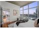 Bright bedroom with hardwood floors, city views, and an open doorway at 1700 Bassett St # 1612, Denver, CO 80202