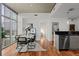 Dining room with a modern table set, hardwood floors and views of the city through floor-to-ceiling windows at 1700 Bassett St # 1612, Denver, CO 80202