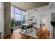 Bright dining room with modern decor, wood floors, large windows, and city views at 1700 Bassett St # 1612, Denver, CO 80202