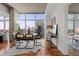 Modern dining room with sleek furniture, wood floors, and a large window overlooking the city at 1700 Bassett St # 1612, Denver, CO 80202