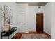 Hallway with decorative table, wood floors, and doors at 1700 Bassett St # 1612, Denver, CO 80202