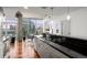 Open kitchen design with black countertops, stainless steel appliances and city views from large windows at 1700 Bassett St # 1612, Denver, CO 80202