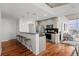 Modern kitchen with bar seating, stainless steel appliances, and hardwood floors at 1700 Bassett St # 1612, Denver, CO 80202