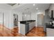 Bright kitchen with sleek gray cabinets, black countertops, stainless steel appliances and hardwood floors at 1700 Bassett St # 1612, Denver, CO 80202