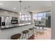 Modern kitchen with stainless steel appliances, breakfast bar, and open floor plan to dining area with city view at 1700 Bassett St # 1612, Denver, CO 80202
