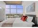 Bright primary bedroom with a queen bed, big windows and expansive city views at 1700 Bassett St # 1612, Denver, CO 80202