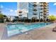 Outdoor pool with an adjacent condo tower and surrounding lounge chairs at 1700 Bassett St # 1612, Denver, CO 80202