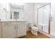 Modern bathroom features white vanity, toilet, and glass-enclosed shower at 245 Washington St, Erie, CO 80516