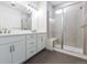 Modern bathroom featuring dual vanity, walk-in shower and neutral color palette at 245 Washington St, Erie, CO 80516