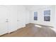 Well-lit bedroom with laminate flooring and large windows at 245 Washington St, Erie, CO 80516