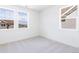 Spacious bedroom with three windows letting in natural light at 245 Washington St, Erie, CO 80516