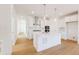 Modern white kitchen with stainless steel appliances and large island at 245 Washington St, Erie, CO 80516