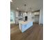 Modern kitchen featuring a large island, white cabinetry, and stainless steel appliances at 245 Washington St, Erie, CO 80516