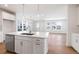 Bright, open-concept kitchen with stainless steel appliances and eat-in island at 245 Washington St, Erie, CO 80516