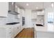 Close-up of a well-appointed white kitchen with stainless appliances and granite countertops at 245 Washington St, Erie, CO 80516