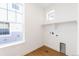 New laundry room featuring laminate flooring and a bright window at 245 Washington St, Erie, CO 80516