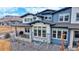 Aerial view of the house showing a well-manicured lawn, a patio, and a modern design at 19755 W 57Th Cir, Golden, CO 80403