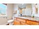 Well-lit bathroom features a granite countertop vanity and a modern toilet for added convenience at 19755 W 57Th Cir, Golden, CO 80403
