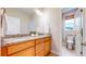 Bathroom featuring a double vanity with granite countertops and a separate toilet room at 19755 W 57Th Cir, Golden, CO 80403