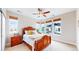 Inviting bedroom with wooden furniture, ceiling fan, and large windows offering natural light at 19755 W 57Th Cir, Golden, CO 80403