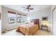 Bright bedroom featuring a ceiling fan, three large windows, and comfortable decor at 19755 W 57Th Cir, Golden, CO 80403