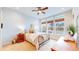 Bright bedroom boasts large windows, ceiling fan, and cozy furnishings for a relaxing retreat at 19755 W 57Th Cir, Golden, CO 80403