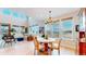 Elegant dining area with a chandelier and large windows offering scenic views at 19755 W 57Th Cir, Golden, CO 80403