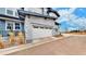 Attached two-car garage with stone accents and a well-maintained driveway at 19755 W 57Th Cir, Golden, CO 80403
