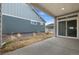 View of back patio with sliding door to the home and partial view of the yard between homes at 5108 N Quatar St, Aurora, CO 80019