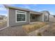 Home's back exterior showcasing low-maintenance landscaping, siding, and covered patio with privacy from neighbors at 5108 N Quatar St, Aurora, CO 80019