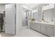 New bathroom featuring a glass shower, sleek vanity with dual sinks, and elegant tile work at 5108 N Quatar St, Aurora, CO 80019