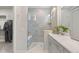 Modern bathroom boasts a glass-enclosed shower, dual vanity, and a walk-in closet for ample storage at 5108 N Quatar St, Aurora, CO 80019