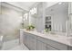 Contemporary bathroom features a glass shower, sleek vanity with dual sinks, and elegant tile work at 5108 N Quatar St, Aurora, CO 80019