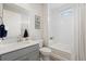 Bathroom with vanity, sink, mirror, toilet, bathtub, tile, and lighting at 5108 N Quatar St, Aurora, CO 80019