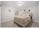 Serene bedroom with neutral walls, plush carpet, a large bed, and decorative wall accents at 5108 N Quatar St, Aurora, CO 80019