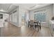 Bright dining room featuring wood floors, a modern table set, and sliding glass doors to the backyard at 5108 N Quatar St, Aurora, CO 80019