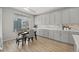 Dining area with gray cabinetry, neutral décor, and natural light from a large window at 5108 N Quatar St, Aurora, CO 80019