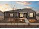 Charming single-story home featuring stone accents, a covered porch, and manicured front yard at 5108 N Quatar St, Aurora, CO 80019