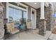 Charming front porch with stone accents, seating, a window, and inviting entryway for relaxing or welcoming guests at 5108 N Quatar St, Aurora, CO 80019