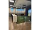 Brightly lit game room includes golf simulator and a large counter with bar stool seating at 5108 N Quatar St, Aurora, CO 80019