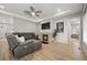 Modern living room featuring a fireplace, ceiling fan, and seamless entryways at 5108 N Quatar St, Aurora, CO 80019