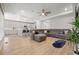 Bright living space with open concept layout, wood floors, fireplace, and sectional sofa at 5108 N Quatar St, Aurora, CO 80019
