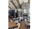 Lounge area showcasing high ceilings, stone fireplace, modern lighting, and comfortable seating at 5108 N Quatar St, Aurora, CO 80019