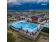 Aerial view of community pool featuring multiple lap lanes, a lounging area, and a clubhouse at 5108 N Quatar St, Aurora, CO 80019