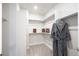 Organized walk-in closet with ample shelving and hanging space, providing plenty of storage at 5108 N Quatar St, Aurora, CO 80019