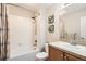 Bathroom featuring a shower-over-tub, vanity with a sink, tiled floor, and walls at 11332 E 111Th Ave, Commerce City, CO 80640