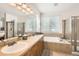 Bright bathroom features double sinks, soaking tub, and separate glass-enclosed shower at 11332 E 111Th Ave, Commerce City, CO 80640