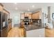 Open kitchen featuring hardwood floors, granite countertops, stainless steel appliances and ample cabinet space at 11332 E 111Th Ave, Commerce City, CO 80640