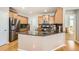 Bright kitchen featuring hardwood floors, granite countertops, stainless steel appliances, and ample cabinet space at 11332 E 111Th Ave, Commerce City, CO 80640